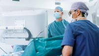 Surgeons performing surgery in operating room.